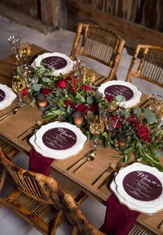 the table is set with plates and place settings for guests to sit down at it