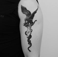 a woman with a snake and bird tattoo on her arm