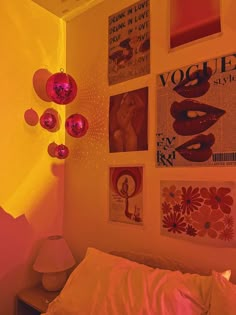 a bedroom with posters on the wall and pink lights in the corner above the bed