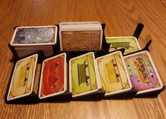 a group of cards sitting on top of a wooden table next to an open box