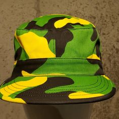 Green Black And Yellow Hat. Sizes Small And Medium. Green Military Brimmed Hat, Green Military Hat With Curved Brim, Military Style Hat For Streetwear, Black Military Brimmed Hat, Black Brimmed Military Hat, Adjustable Military Cap, Casual Camouflage Flat Cap, Green Military Bucket Hat With Short Brim, Green Military Bucket Hat