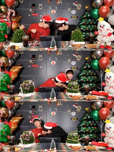 two people sitting at a table in front of balloons and christmas trees with santa hats on