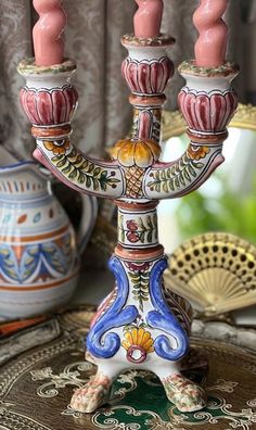 an ornately decorated candelabra with three candles