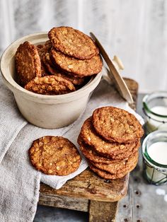 a bowl filled with cookies next to some milk