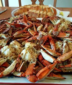 a large pile of cooked crabs on a table