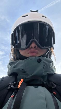 a woman wearing ski goggles and a helmet