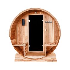 a wooden sauna with two benches in the middle and a black door behind it