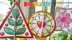 colorful paper flowers and leaves are hanging from the ceiling in front of a potted plant