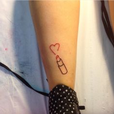 a woman's arm with a tattoo on it that has a bottle and a heart