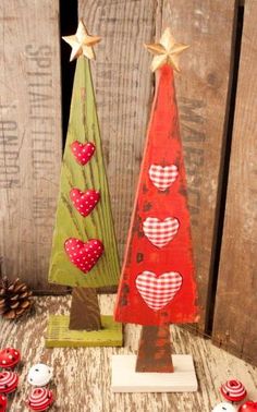 two wooden christmas trees with hearts on them