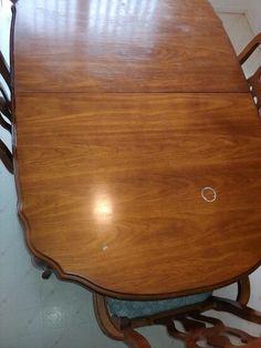 a wooden dining table with chairs around it