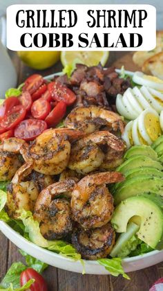 grilled shrimp cobb salad with avocado, tomatoes and lettuce on the side