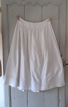 Antique french cotton petticoat. With fine pleated and ricrac frill. Glass button waist fastening. In good antique condition commensurate with age. One rust spot near the hem. some tiny pin holes where it has been taken up and ket down and a fine darn. Measures 34" 86cm around the waist  Length 36" 91cm 266g Cotton Bottoms With Pleated Hem For Daywear, Cotton Lined Petticoat Skirt, Classic Full Skirt Cotton Bottoms, Vintage Full Skirt For Daywear, Classic Cotton Gathered Skirt, Vintage Full Skirt Bottoms With Ruffles, Classic Cotton Skirt For Daywear, Vintage Tiered Skirt For Daywear, Cotton Petticoat With Gathered Skirt For Daywear