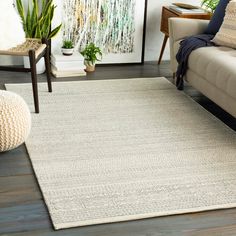 a living room with a couch, chair and rug