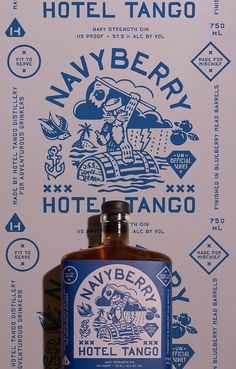 a bottle of whiskey sitting on top of a table next to a sign that says navy berry hotel tango