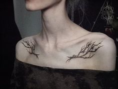 a woman's chest with branches on it