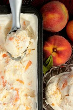 two scoops of ice cream in a pan next to peaches on a table