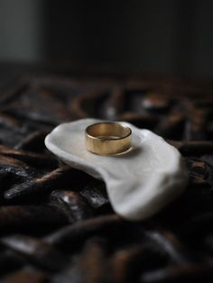 a gold ring sitting on top of a white napkin