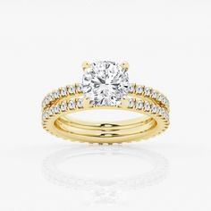 a yellow gold engagement ring set with a round diamond center and two rows of diamonds around the band