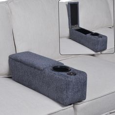 a couch with a cell phone holder attached to it's back and the seat up