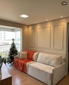 a living room filled with furniture and a christmas tree