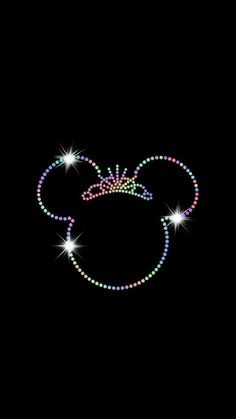 the mickey mouse head is made up of multicolored beads and sparkles on a black background