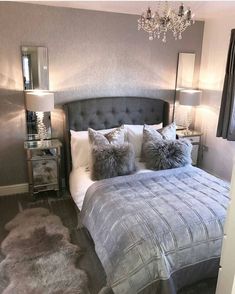 a bedroom with a bed, nightstands and chandelier