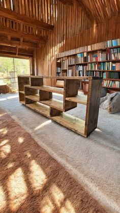 a wooden bench sitting inside of a library filled with books