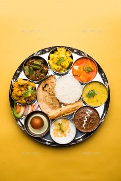 a plate full of different types of food on a yellow background - stock photo - images