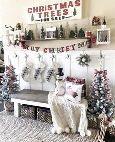 christmas stockings and snowmen are hung on the wall above a bench in front of a fireplace