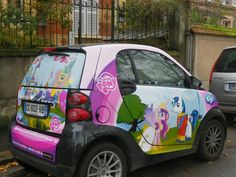 a car that has been painted with pony pictures on it