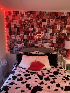 a bed room with a neatly made bed and lots of pictures on the wall