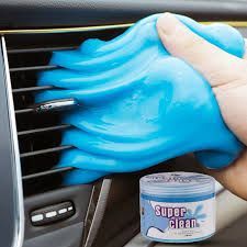 someone is cleaning the air conditioner in their car with blue cloths and a cup