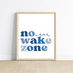 a framed poster with the words no wake zone on it in blue and black ink