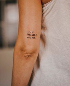 a man with a tattoo on his arm that says trust, breathe, repeat