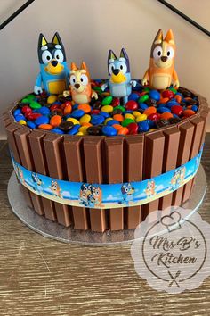 a cake decorated with cartoon characters on top of it