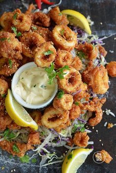 fried shrimp with lemon wedges and cole slaw