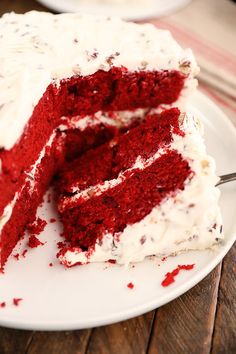 a red velvet cake with white frosting on a plate