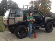 a man standing in front of a jeep