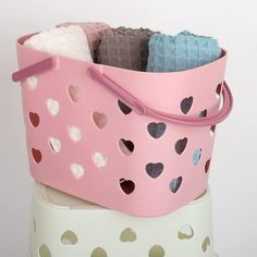 a pink basket filled with lots of hearts