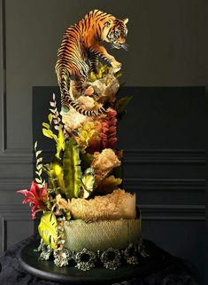 there is a cake that looks like a tiger on top of plants and other things