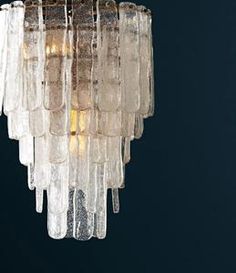 a chandelier made out of ice cubes hanging from a ceiling fixture in a dark room