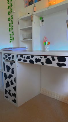 a cow print painted on the side of a desk