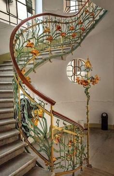 a spiral staircase with flowers painted on it