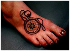 a person with a compass tattoo on their foot