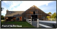 a large barn with a white fence around it's perimeter and the words front of the barnhouse