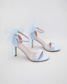 Classic satin high heel sandals adorned with tulle bow and ankle strap for romantic, elegant and feminine look. The light blue color can easily be your something blue. Simple and easy wear for bridal wear, bridesmaids, holiday party, wedding parties, and any special occasions. DETAILS: HEEL HEIGHT: 3.5 Inches Color Available: White, Ivory, Light Blue UPPER: Synthetic upper and lining MATERIALS: Manmade outsole ORIGIN: Imported STYLE NAME: DEMI Not sure of which size to purchase? Shoes measurements are as follow: (Please note measurements taken the length of inside of shoe from toe to heel). Size 6 - 9.25" Size 7 - 9.5" Size 8 - 9.75" Size 9 - 10" Size 10 - 10.25" Size 11 - 10.5" Please note all these info are intended for general reference and are to be used as a guide only. Age and size w Open Toe Tulle Heels For Party, Tulle Open Toe Heels For Party, Ankle Strap Tulle Heels For Parties, Tulle Ankle Strap Heels For Party, Formal Tulle Open Toe Heels, Formal Tulle High Heels, Summer Wedding Tulle Heels, Spring Formal Tulle Heels, Elegant Tulle Heels With Open Toe