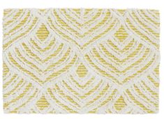 a yellow and white rug with an intricate design on the bottom, in front of a white background