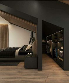 a bedroom with black walls and wooden flooring is shown in this image, there are closets on either side of the bed