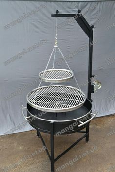 an outdoor bbq grill with two pans hanging from it's sides and the top